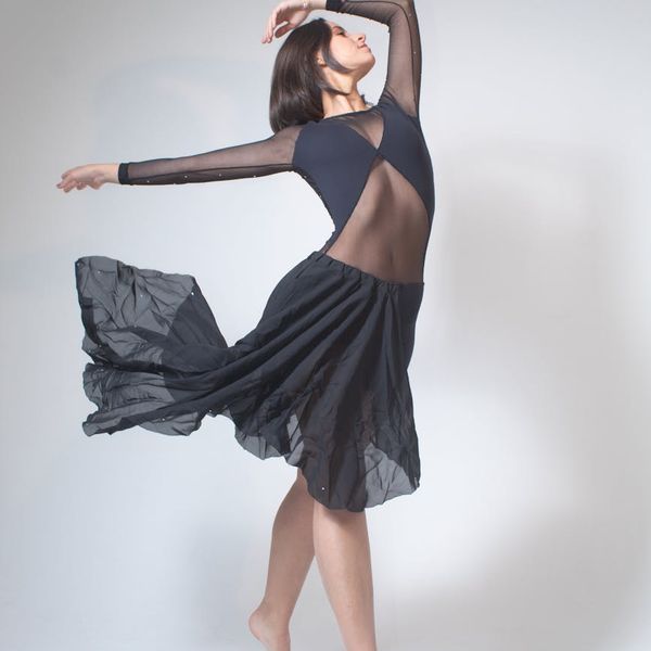 Person in a flowing movement pose, embodying flexibility and grace.