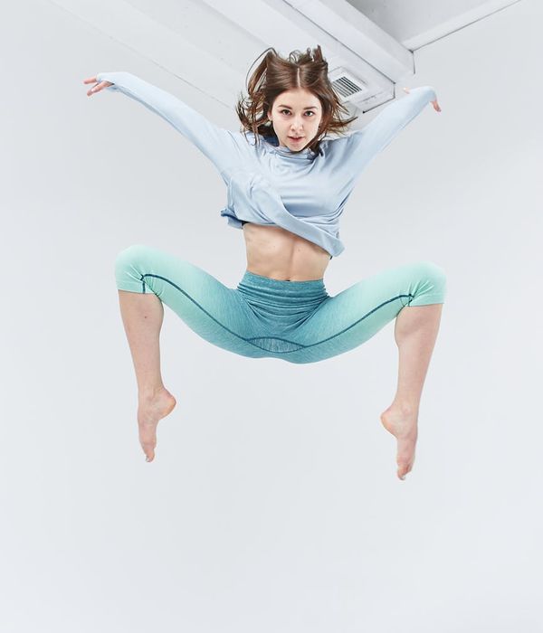 Woman in a dynamic cardio pose, feeling energetic and light.